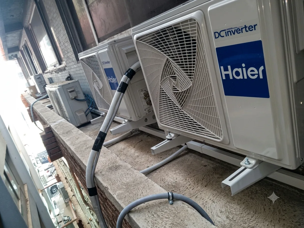 Outdoor air conditioning condensing units installed along a building balcony